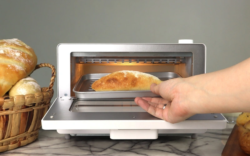 Oven toaster showing versatile cooking options for baking, toasting, broiling, and roasting in one appliance